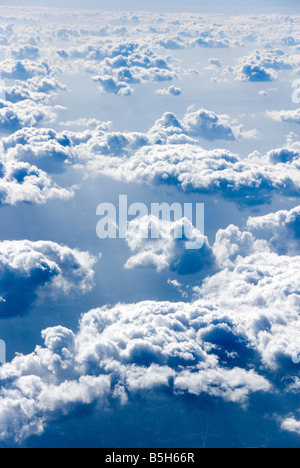 View above fluffy clouds at high altitude Stock Photo