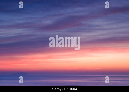 A pastel coloured sunset taken at Sandpoint near Weston Super Mare with Steepholm Island just visible in the background Stock Photo