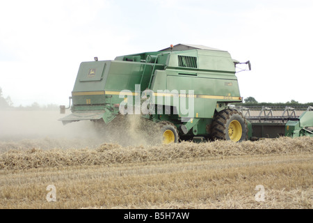 A John Deere Combine Harvester hard at work. Stock Photo