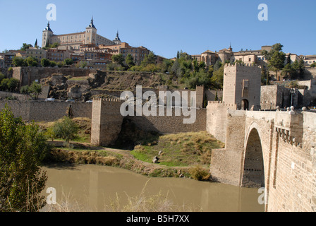 view with Puente de Alcantara across the Tajo River to city of Toledo, Castile-La-Mancha, Spain Stock Photo