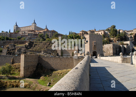 view across Puente de Alcantara and Tajo River to city of Toledo, Castile-La-Mancha, Spain Stock Photo