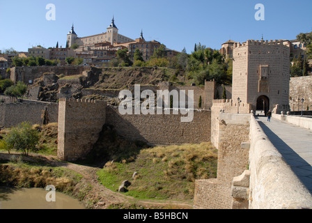 view across Puente de Alcantara and Tajo River to city of Toledo, Castile-La-Mancha, Spain Stock Photo