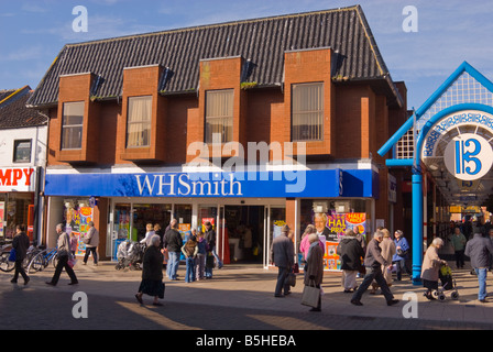 People walking past WHSmith the newsagent in the busy town centre of Lowestoft Suffolk Uk Stock Photo
