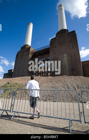 A person looking up at Battersea Power Station Stock Photo