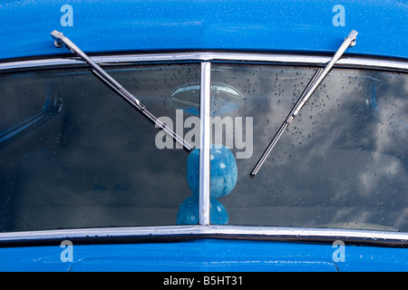 Windshield wipers and rain on antique car windscreen Stock Photo