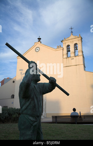 Statue of Olive beater in front of Church of Our Lady of Guadalupe, Baena, Cordoba Province, Andalucia, Spain Stock Photo