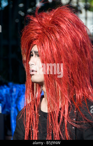 Young man in a red wig at a visual kei event in Harajuku Tokyo Japan Stock Photo