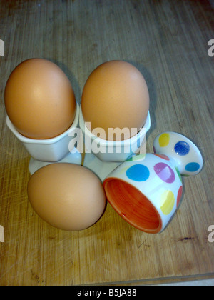 three eggs yolk cups accident kitchen cook poach boil scramble fried  crack shell albumen chicken hen breakfast free range barn Stock Photo