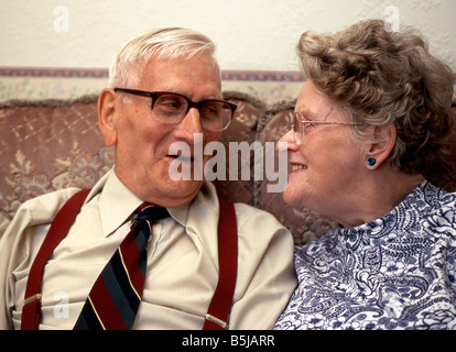 Senior couple sitting together on a sofa Stock Photo