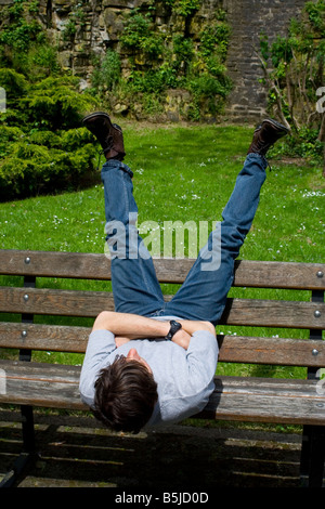 Man lying on the bench in the park Luxembourg june 2006 Stock Photo