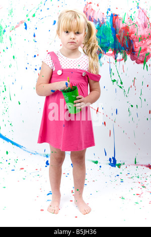 Pretty Little Girl  art student, painting with paint splashes, graphic smears, daubs and smudges. Stock Photo