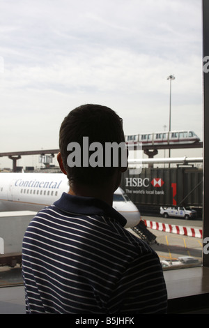 Man looking out of a window of Houston International Airport, Texas, USA Stock Photo