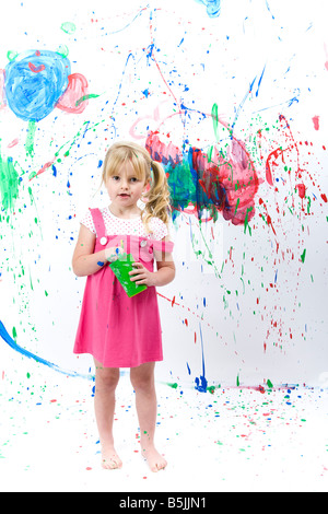 Pretty Little Girl  art student, painting with paint splashes, graphic smears, daubs and smudges. Stock Photo