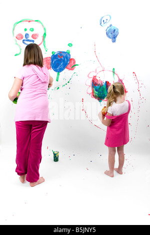 Pretty Little Girl  art student, painting with paint splashes, graphic smears, daubs and smudges. Stock Photo