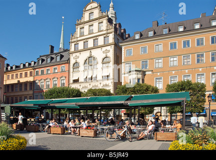 People enjoying hot summers day in outdoor cafe Gamla Stan Stockholm Sweden Stock Photo