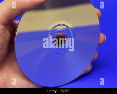 A hand holding a CD. Stock Photo