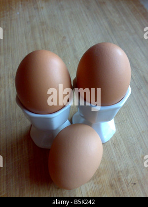 three eggs yolk cups accident kitchen cook poach boil scramble fried  crack shell albumen chicken hen breakfast free range barn Stock Photo