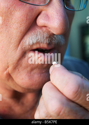 elderly Man Taking tablet Stock Photo