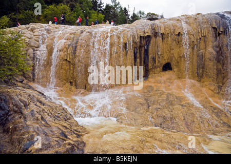 Travertine calcified Golden Flying Waterfall in Huanglong Sichuan Province China with tourists walking on top JMH3526 Stock Photo