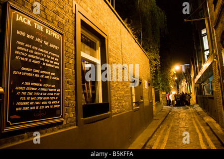 A guided tour in an alley outside The White Hart Pub where Jack The Ripper lived in East London Stock Photo