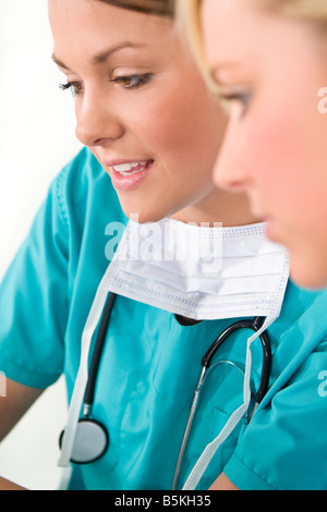 Two beautiful young women doctors in discussion Stock Photo