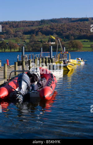 A Red Zodiac Rib and Yellow Rescue Boat Moored to Pier on Coniston Water at Time Trials Lake District National Park Cumbria UK Stock Photo