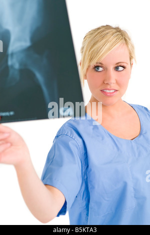 A female doctor examining an X ray of a human hip Stock Photo
