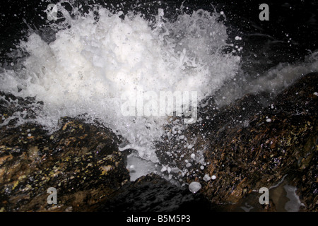 Waves breaking at night lit by flash Stock Photo