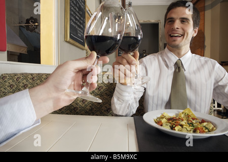 Two men having a toast at dinner. Stock Photo