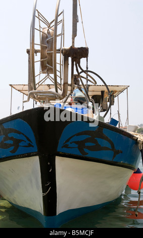 National Cyprus fishing boats in harbour Aiga Napa detail of the net winch and blue white ship prow with dolphin paintings Stock Photo