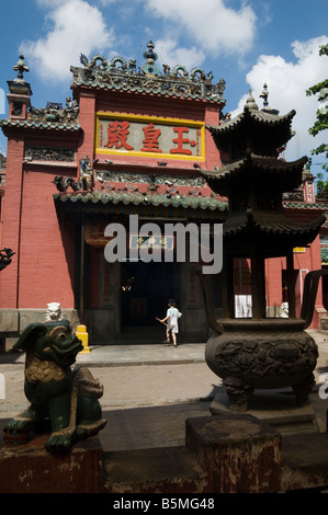 Young boy enters the Emperor of Jade Pagoda built in 1909 by the Cantonese Congregation, Ho Chi Minh City, Vietnam, Stock Photo