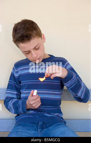Boy lighting match Stock Photo