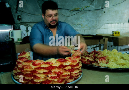 A chef prepares a display of Arabic sweets in a patisserie in Sidon's souk, in southern Lebanon Stock Photo