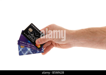 mans male right outstretched hand holding a selection of credit cards against a white background Stock Photo