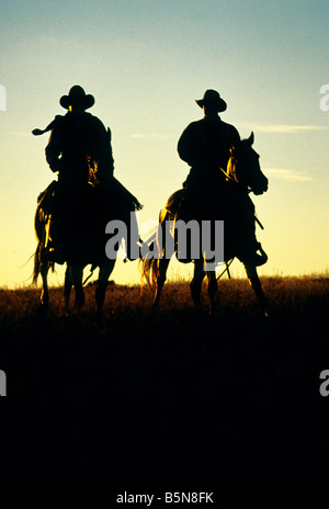Cowboys hitting the trail at sunrise. Stock Photo