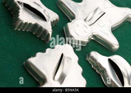 Vintage tin Christmas cookie cutters still life on green background Stock Photo