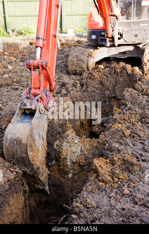 Digging a trench with a digger while preparing the footings Stock Photo ...