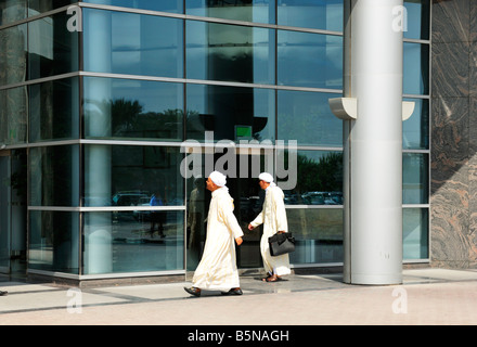 Two Arabian Businessmen in front of a bank, Dubai UAE Stock Photo