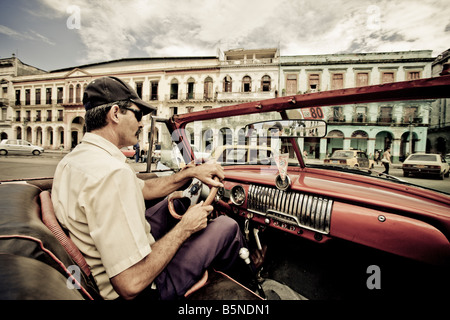 Driving a 1952 American Chevrolet through Old Havana Cuba Stock Photo