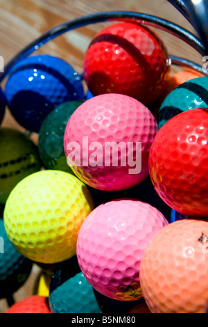 A basket of variously colored golf balls. Stock Photo