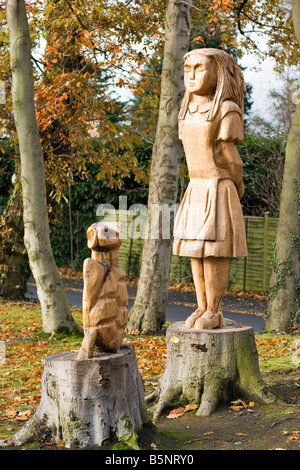 Statues of Alice in Wonderland and the Mock Turtle, carved out of tree trunks in Edenvilla Park, Portadown Stock Photo