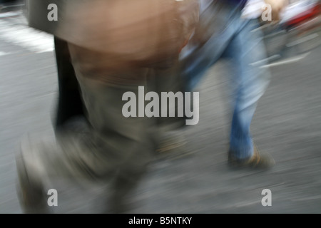 business man walking in street in city town Stock Photo