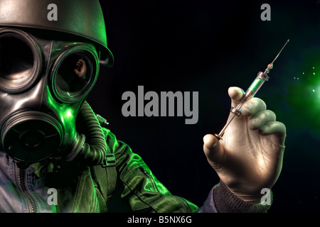 Gas masked man holding a syringe Stock Photo