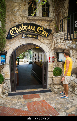 Tourist standing outside Chateau Eza Restaurant, in the medieval village of Eze, near Monaco, France Stock Photo