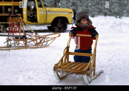 Young Child holding Sled at the International Sled Dog Race near Falkland in the Okanagan Region of British Columbia Canada Stock Photo