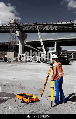 Female Surveyor working on Freeway 4 connector Downtown Orlando Florida USA Stock Photo