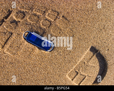 A digital computer memory stick lost on a sandy beach Stock Photo