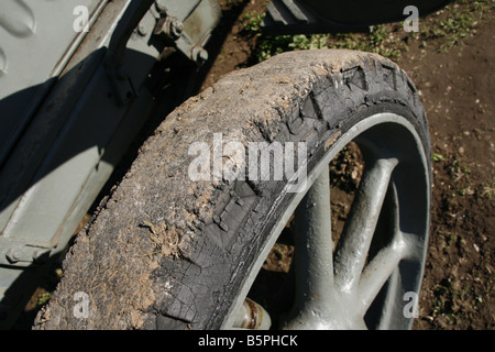 soil and dirt on old militray vehicle tyre in field Stock Photo