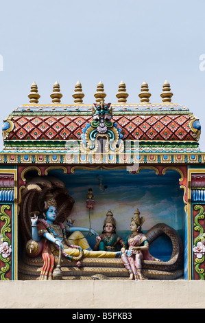 Hindu deities, painted statues, on a temple gopuram in Bangalore. India Stock Photo