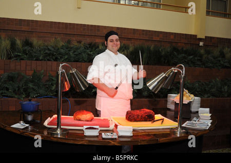 smiling young service man with knife posing for photographer Stock Photo